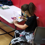 A student at the Community Learning Collaborative paints